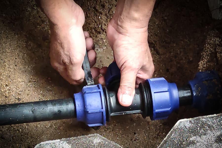 A water supply pipe repair being performed by an engineer.